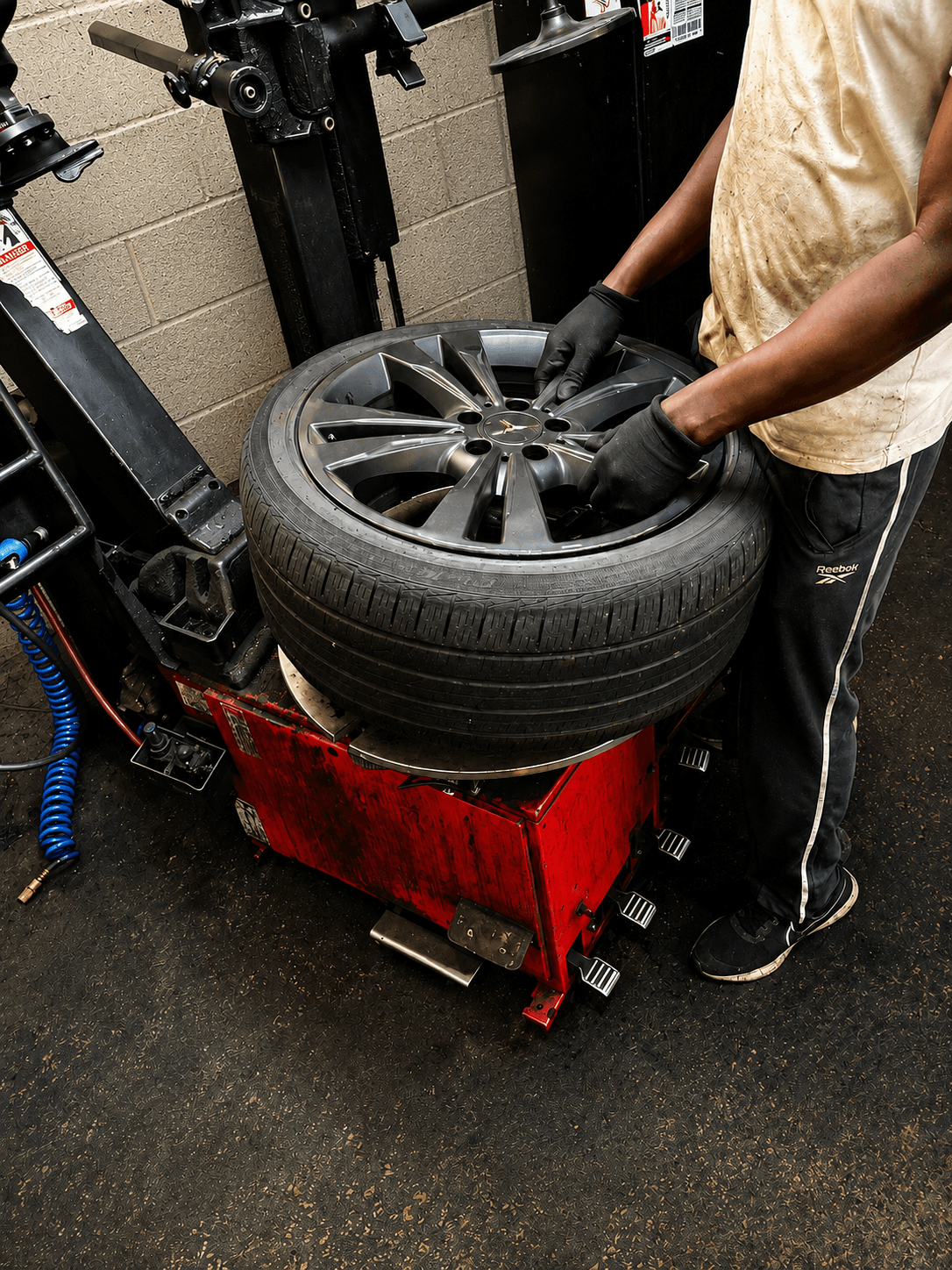 Technician mounting tire on rim